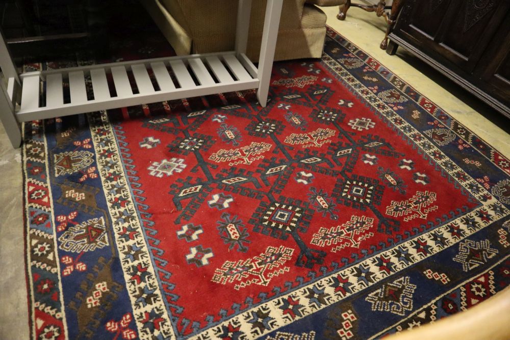 A Caucasian design red ground carpet, 285 x 194cm